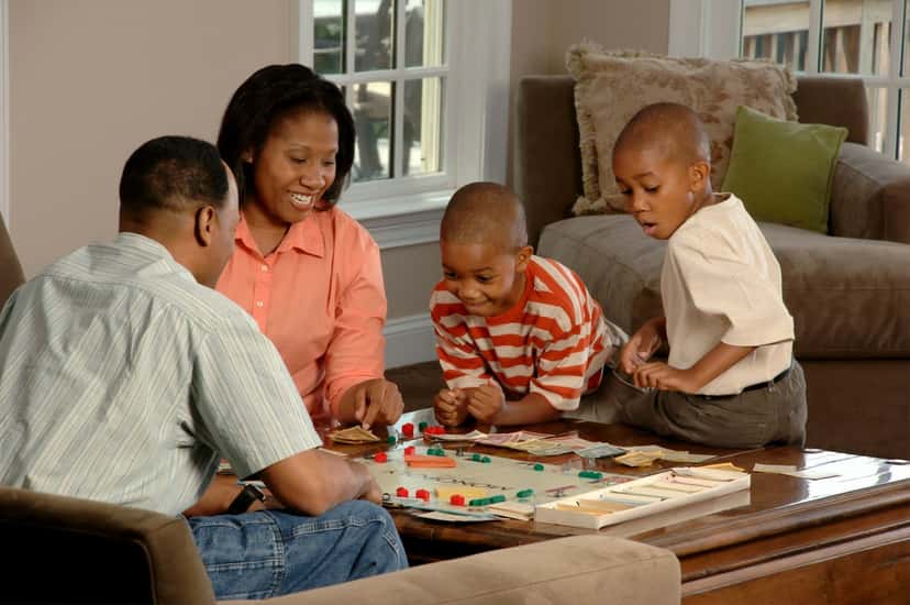A family playing a board game together in their living room
