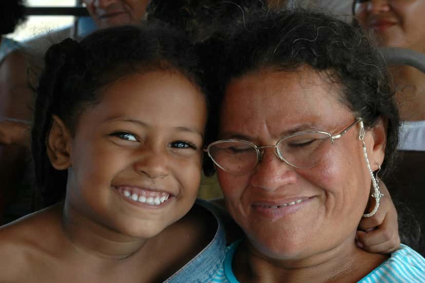 A grandmother and her granddaughter smiling cheek to cheek