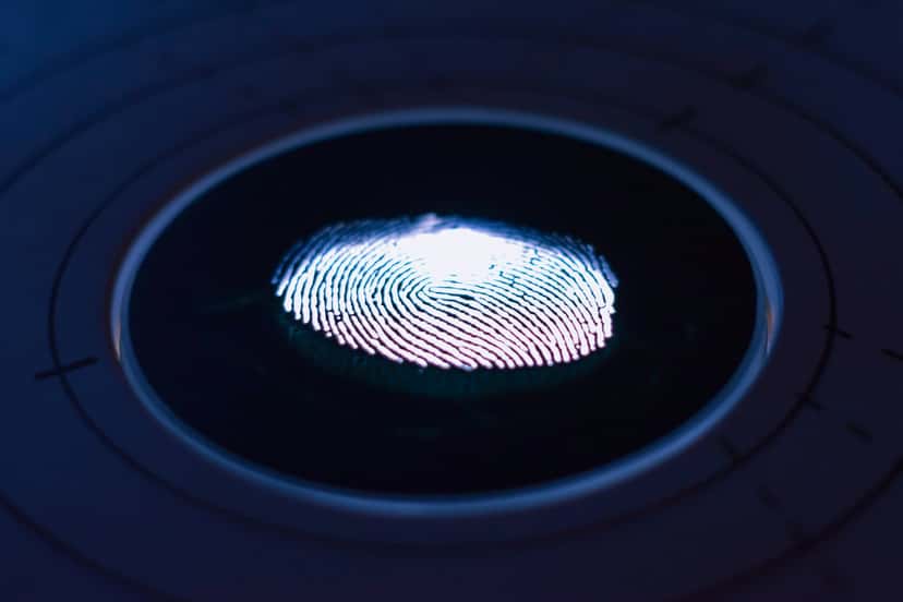 Close-up of a fingerprint on a glowing scanner